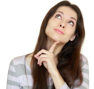 Thinking Girl Looking Up With Finger At Face With Smile Isolated