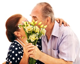 25499221 - old man embracing woman sharpness on the bouquet